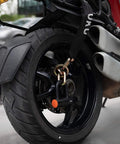 Rear motorcycle wheel secured with Ultra Security Chain Beefy Heavy Duty Four Foot By Half Inch Hardened Alloy Steel Links and lock
