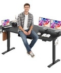 Stunning Sanodesk 79 Inch By 32 Inch Electric Height Adjustable Standing Desk with two monitors and user in modern office setup.