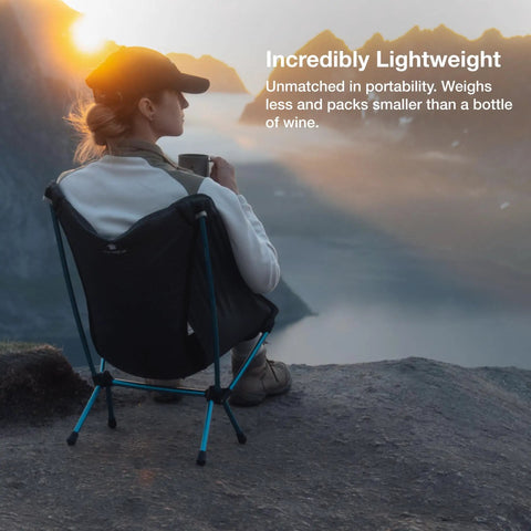 Person sitting on ultralight backpacking camp chair at mountain overlook, chair packs smaller than a water bottle, weighs 1.1 lbs