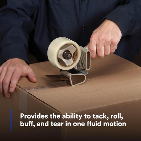 Side view of a gray 3M Scotch H180 packing tape dispenser (metal/plastic) applying tape to a cardboard box.