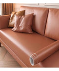 Self Adhesive Waterproof PU Leather Repair Patch With Lychee Texture For Sofas Chairs And Car Seats No Mess Easy Fix In A 60 By 50 Cm Size Durable Scratch Resistant Patch For Worn Edges And Tears On Furniture And Auto Interiors displayed on a cushioned sofa