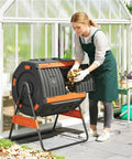 Person adding leaves to 53 Gallon Dual Chamber Compost Tumbler With Geared Rotation Adjustable Vents Elevated Base And Lockable Handle
