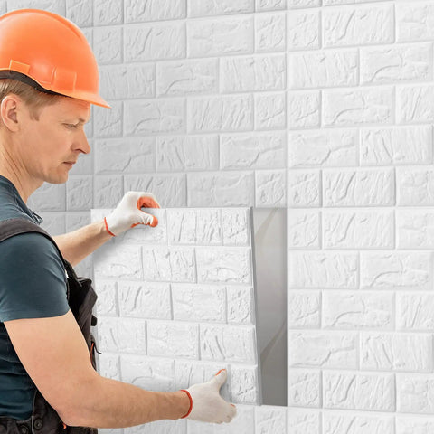 Man installing 30 Piece 3D White Brick Peel And Stick Foam Wall Panels For A Quick Home Flip on a wall.