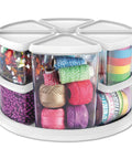 Rotating Craft Organizer Carousel With Nine Removable Canisters And Clear Lids filled with colorful craft supplies