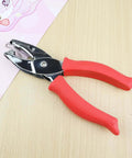Square Hole Paper Punch 3 Sixteenth Inch Handheld Puncher with red soft grip handle on a wooden table