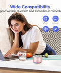 Woman using laptop with Tiny But Mighty Grab And Go Metal Bluetooth Speaker with Lights and Lanyard 5W Mini Wireless.