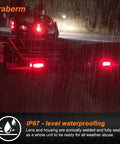Heavy Duty Steel Trailer Light Box Housing Kit With 6 Inch Oval Red LED Taillights And 2 Inch Round Red Marker Lamps at night in rain