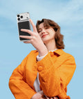 Compact Foldable MagSafe Power Bank 10000 Mah Featuring Dope Magnetic Alignment For iPhone 16 15 14 Series, held by a woman in an orange jacket.