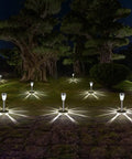 Stainless Steel Glass Solar Outdoor Lights 8 Pack Super Bright Lit Pathway Garden Landscape Lights illuminating a yard at night