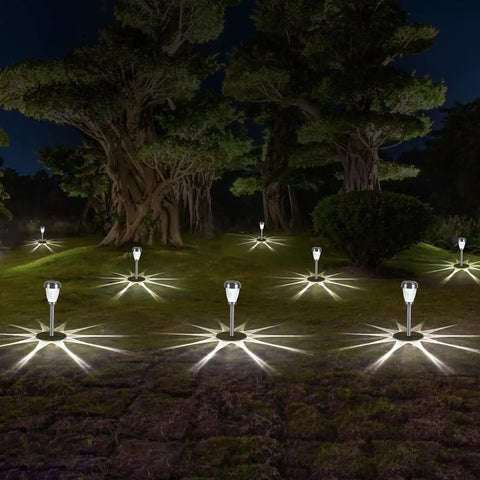 Stainless Steel Glass Solar Outdoor Lights 8 Pack Super Bright Lit Pathway Garden Landscape Lights illuminating a yard at night