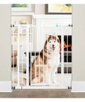 Extra Tall Walk Through Dog Gate For Doorways And Stairs Metal Pet Gate With Small Pet Door Expands From Twenty Nine And A Half To Thirty Six And A Half Inches White Secure Indoor Barrier For Big And Jumpy Dogs shown with a husky behind it in a living room setting.