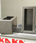 KAKA sheet metal brake box and pan components, stainless steel, front and side views on a workbench