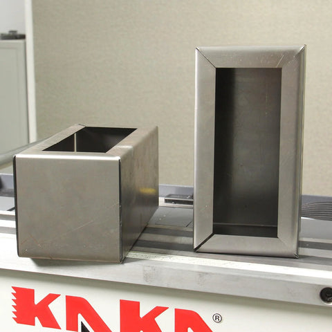 KAKA sheet metal brake box and pan components, stainless steel, front and side views on a workbench