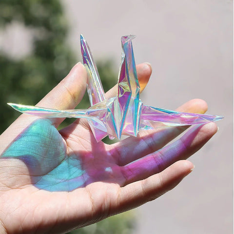 Iridescent Cellophane Wrapping Paper Roll For Flower Bouquets And Wine Bottles Multicolor Gift Wrap For Weddings And Parties Can Be Cut To Size Durable Packaging Paper For Gifts That Pop folded into origami crane on hand