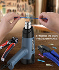Beast 1500W Heat Gun Kit With Variable Temperature Control And Twin Airflow Settings Hot Air Gun For Crafts And Shrink Wrap 120F To 1200F Range Includes 4 Nozzles Blue in use on a workbench with tools.