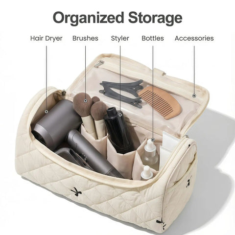 Open quilted hair tools travel bag with hanging hook showing hair dryer, brushes, and styling accessories neatly organized