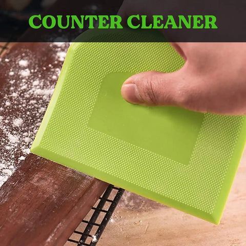 Close-up of hand using green piece from 3-Piece Flexible Dough Scraper Bench Set, 4.7x3.7 Inch Bowl Scraper With Sharp Edge And Angles, Non-Slip Bakeware Tool For Kneading, Scraping, Decorating, Sculpting And Modeling, Green White Green, on wooden surface.