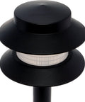 Close-up of the black frame and frosted glass lens of two tier low voltage path stake lights black outdoor garden walkway lighting with slick dope look.