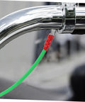 Flexible Brake Line Hose for Motorcycles, Scooters and Dirt Bikes connected to a chrome handlebar with green braided sleeve