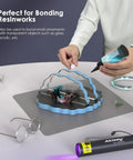 Person using All-In-One UV Resin Kit With Rechargeable 395Nm Light, 50g Fast-Cure Resin on a silicone mat for bonding projects.
