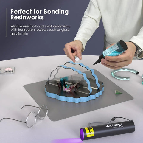 Person using All-In-One UV Resin Kit With Rechargeable 395Nm Light, 50g Fast-Cure Resin on a silicone mat for bonding projects.