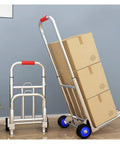 Hella Tough Folding Sack Truck With Solid Rubber Wheels And Rugged Utility Dolly Platform For Zero Sweat Heavy Moving Gear Hauling Up To Two Hundred Forty Two Pounds with stacked boxes.