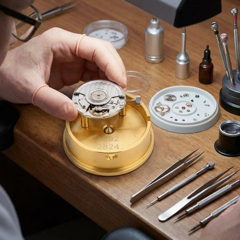 Watch Movement Holder With Durable Aluminum Alloy Base Repair Stand For 2892 And 2824 Movements in use on workbench.