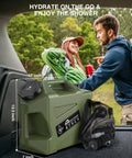 Portable Camping Shower With 5-Gallon Food Grade Water Jug, Rechargeable Battery, Electric Outdoor Shower Pump For Hiking, Beach, Travel, Pet Bath, IPX6 Waterproof, Built Tough No Fuss Setup shown with campers in the background.