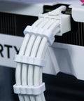 Close-up of white cable with clips from 24 Pack PSU Wire Management Clips Kit For ATX Power Cables, White Cable Organizers For 12VHPWR X4, 24 Pin X4, 8 Pin X16, Fits 3mm To 3.5mm Gauge, Easy Cable Routing, Clean Rig Interior