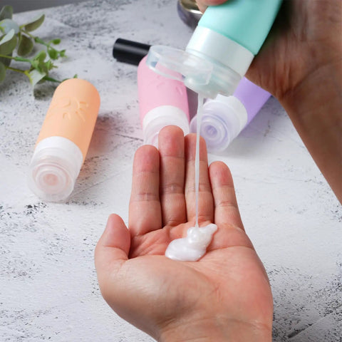 Leak Proof TSA Approved Travel Bottles Set 3oz Refillable Containers in use dispensing lotion into hand