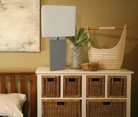 Leather Wrapped Modern Table Lamp With White Fabric Shade In Gray on dresser with woven baskets and decor