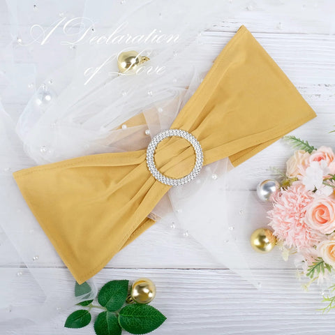 Gold spandex chair sash with circular crystal buckle, front view, wedding banquet decor.