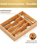 Premium Bamboo Kitchen Drawer Organizer Nine Inch Silverware Tray with curved grooves for easy access to cutlery.