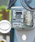 Twelve Pack Half Inch Round Stainless Steel Electrical Box Knockout Plugs For Dead Nuts Secure Panel Sealing and Unused Outlet Closure Trade Grade Heavy Duty Hole Plugs That Lock Tight With No Sweat Setup For Pro Wiring Jobs shown next to a power meter.