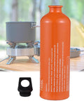 Aluminum Fuel Bottle 750ml For Camping And Outdoor Use, Leak Proof Container For Gas Petrol Kerosene next to camp stove on wood table.
