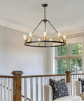 Black And Gold 9 Light Industrial Wagon Wheel Farmhouse Chandelier, 32 Inch Diameter, hanging in elegant living room.