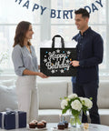Man and woman holding 2 Pack 13 Inch Large Birthday Gift Bags With Tissue Paper And Cards, Reusable Nonwoven Gift Bags With Handles