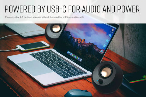Minimalist USB-C Desktop Speakers With Bluetooth 5.0, 8W RMS, sleek black paired with laptop on wooden desk