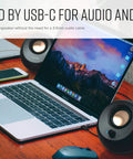 Pebble V3 2.0 USB C Desktop Speakers With USB Audio And Bluetooth 5.0 connected to laptop on wooden desk