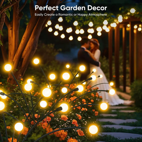 Outdoor Solar Firefly Lights 4 Pack With 32 LEDs Waterproof Pathway Lamps For Yard And Patio Solar Powered Garden Decor That Sways In The Breeze Bright Modern Night Lighting Awesome Gift For Women Moms Friends illuminating a garden path with flower beds at night.