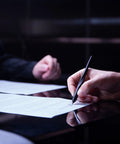 Hand writing with Hoverpen Interstellar Space Black Ballpoint Pen For Desk Aesthetic With Premium Futuristic Design.