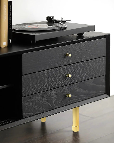 Switch Up Your Setup With These Durable Adjustable Furniture Legs Crafted From Heavy Aluminum Alloy Featuring Quick Height Tweaks On Twist Base Ideal For Beds Couches Cabinets And Shelves Comes In Sweet Gold Sharp Black Or Clean Silver Finishes. View of black dresser with gold adjustable legs and vinyl player.