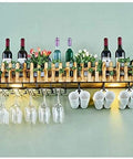 Upgrade Your Home Bar Setup With This Knockout Industrial Ceiling Wine Rack And Wall Mounted Glass Holder Built Pretty Dang Tough With Rustic Wood And Matte Black Steel For Hanging Bottles, showcasing wine bottles and glasses.