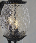 Close-up of a Three Light Outdoor Wall Mount Sconce In Matte Black With Pineapple Cut Glass, showing intricate glass detailing.