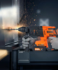 3600W Electric Demolition Hammer Heavy Duty Concrete Breaker in use, drilling into metal with sparks, side view showing user grip