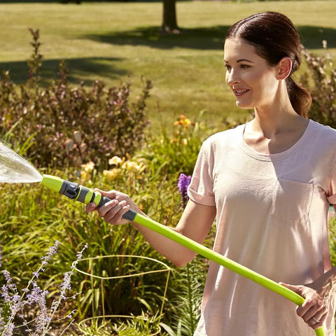 Woman using Garden Hose Five Eighth Inch By Fifty Foot Lightweight All Weather Water Hose With Ultra Flexible Kink Free Design