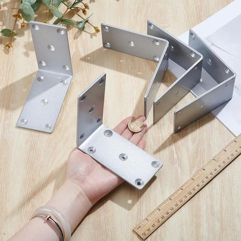 Beefy Heavy Duty L Brackets 4 Pack Solid Steel Right Angle Corner Brackets displayed with a ruler and hand for scale, silver