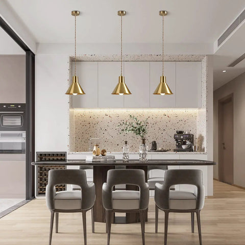 Brushed Gold Modern Cone Pendant Light For Kitchen Island And Hallway Brass Hanging Ceiling Lamp With Vintage Mid Century Charm Retro Style Pendant Fixture For Warm Glow illuminating a modern kitchen.