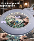 Person using XL Bifocal LED Magnifying Lamp With 7 Inch Acrylic Lens 2.25x And 6x Magnification on circuit board
