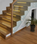 10 Pack 304 Stainless Steel Glass Railing Standoffs With Slick Wire Draw Texture installed on a modern wooden staircase.